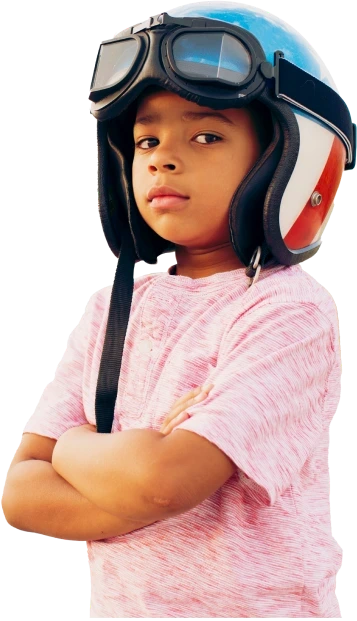A small child in a pink shirt with a retro helmet on